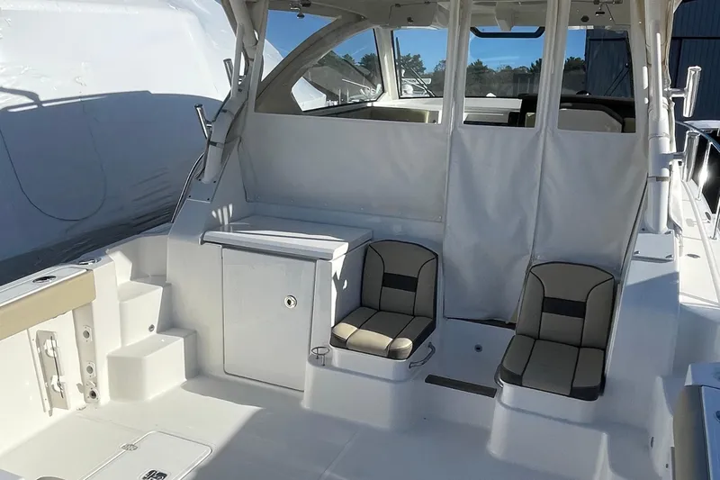  Yacht Photos Pics 2020 Pursuit OS 355 Offshore boat interior with seating and storage compartments.