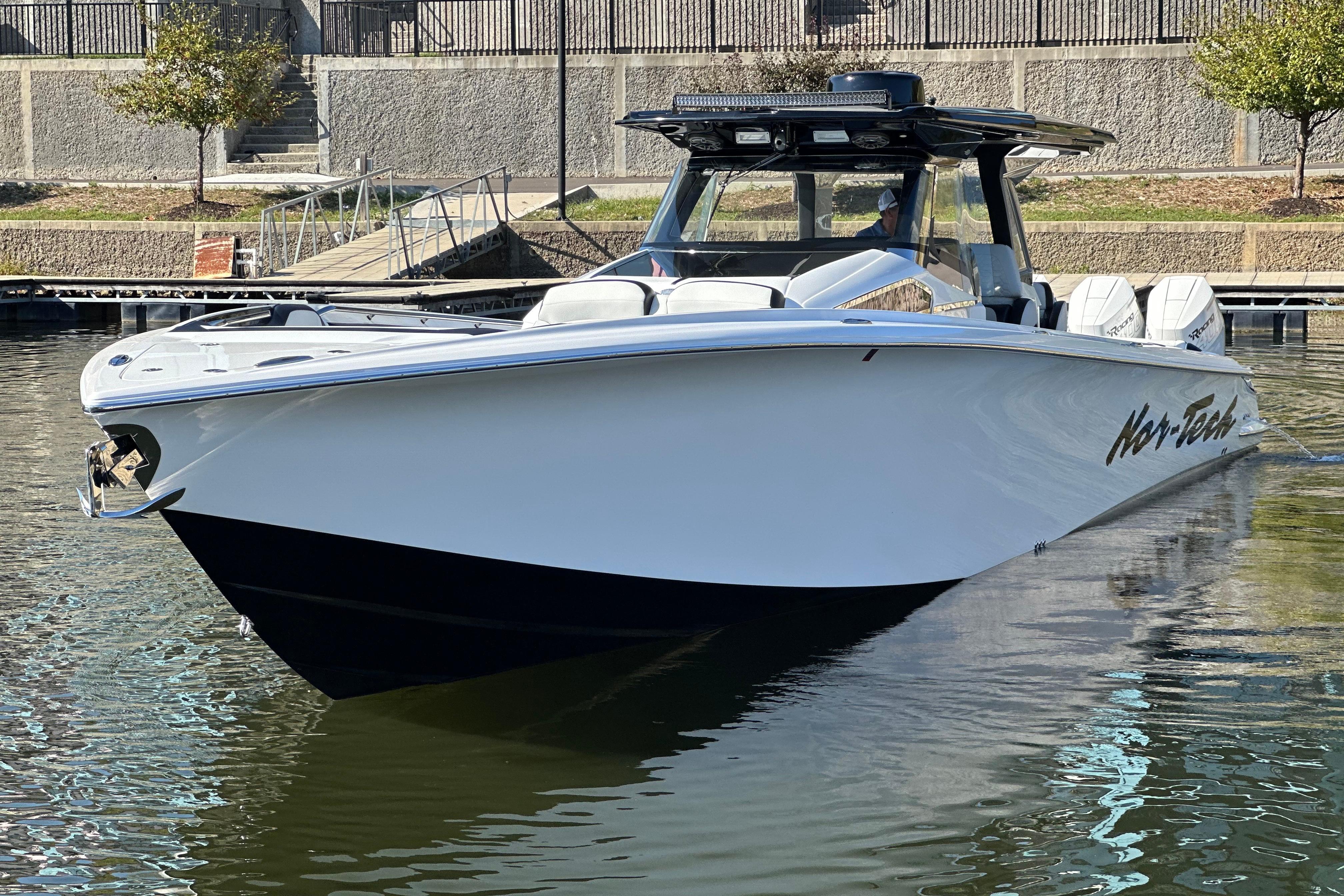 2025 Nor-Tech 450 Sport Center Console boat docked in calm waters.