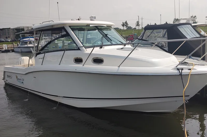  Yacht Photos Pics 2019 Boston Whaler 315 Conquest boat docked in marina, side view.