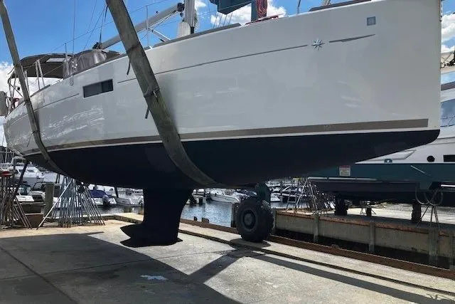  Yacht Photos Pics 2019 Jeanneau Sun Odyssey 349 sailboat in dry dock, side view.