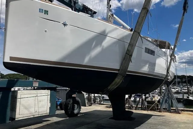  Yacht Photos Pics 2019 Jeanneau Sun Odyssey 349 sailboat in dry dock, side view.