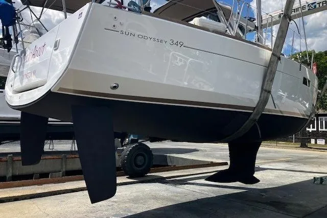  Yacht Photos Pics 2019 Jeanneau Sun Odyssey 349 sailboat in dry dock, showcasing hull and keel.