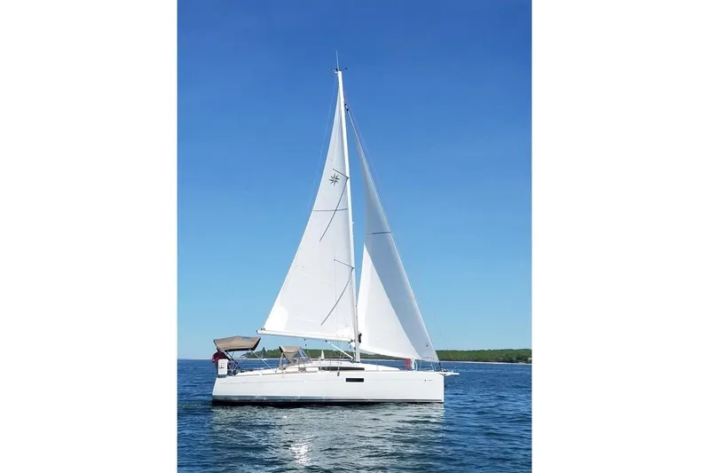  Yacht Photos Pics 2019 Jeanneau Sun Odyssey 349 sailboat on open water under clear blue sky.