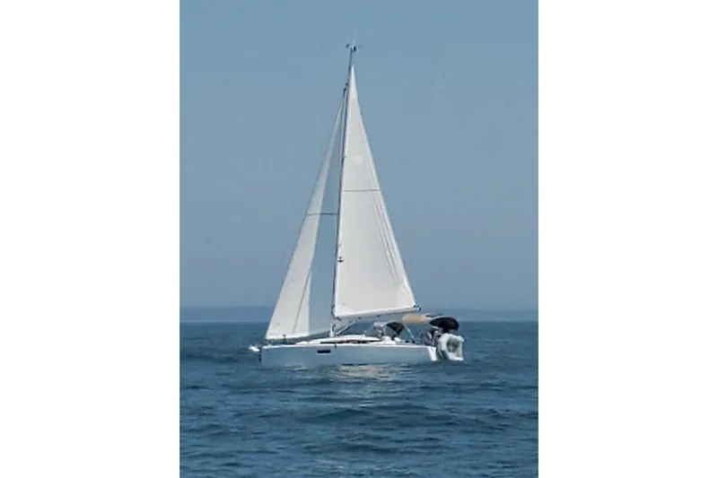  Yacht Photos Pics 2019 Jeanneau Sun Odyssey 349 sailing on open water under clear skies.