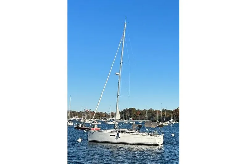  Yacht Photos Pics 2019 Jeanneau Sun Odyssey 349 sailboat on calm water under clear blue sky.
