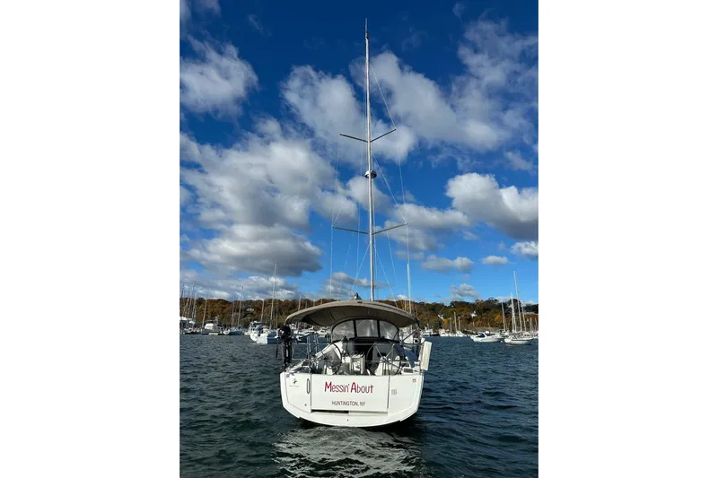  Yacht Photos Pics 2019 Jeanneau Sun Odyssey 349 sailboat on water under a blue sky with clouds.