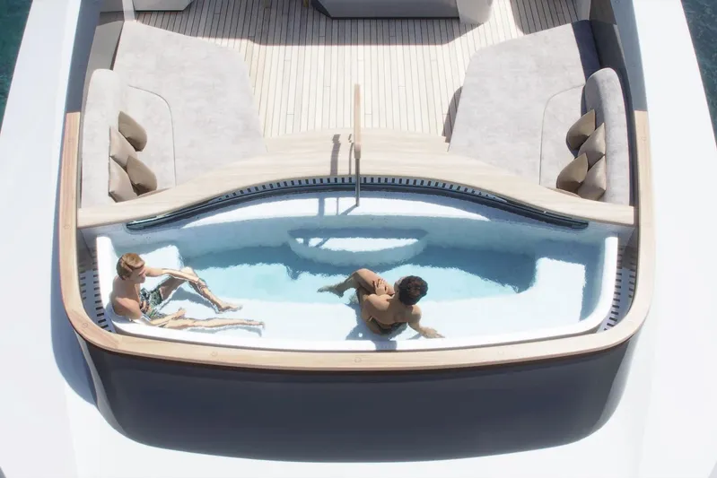  Yacht Photos Pics Luxurious Rossinavi Berserk 47 yacht deck with pool, 2026 model, featuring elegant seating.