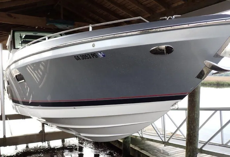  Yacht Photos Pics 2020 Formula 430 Super Sport Crossover boat docked under a wooden shelter.
