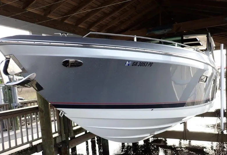  Yacht Photos Pics 2020 Formula 430 Super Sport Crossover boat docked under a wooden shelter.