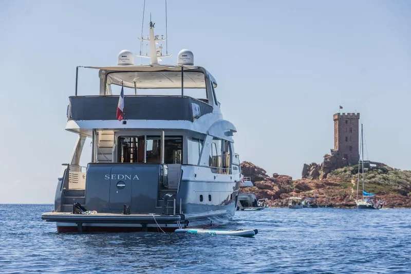 Sedna Yacht Photos Pics Luxury yacht Jet Tern SELENE 72, 2020 model, near a coastal tower.