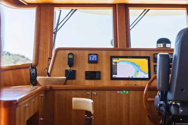Sedna Yacht Photos Pics Helm of 2020 Jet Tern SELENE 72 yacht with navigation equipment and wooden finish.