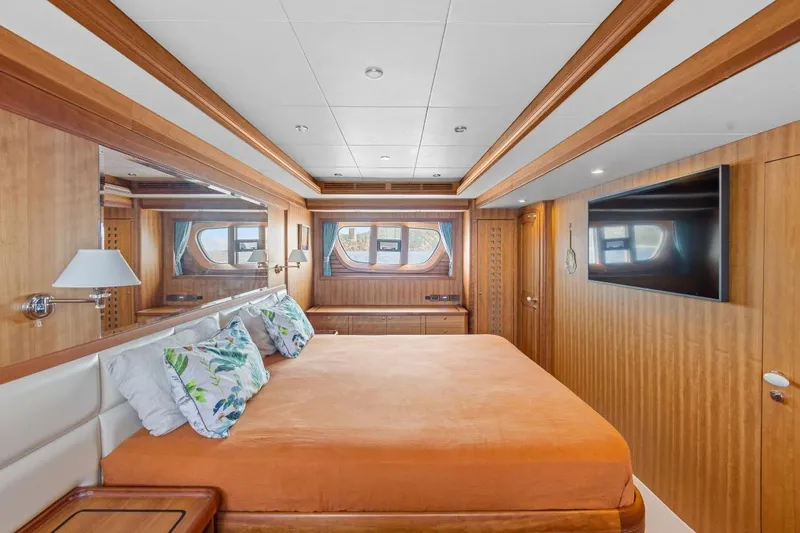 Sedna Yacht Photos Pics Luxurious bedroom interior of 2020 Jet Tern SELENE 72 yacht with wood paneling and large bed.