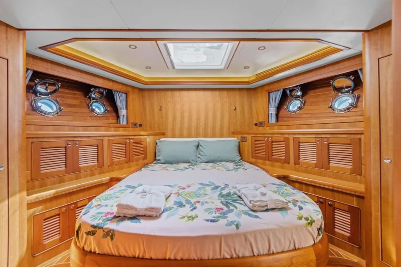 Sedna Yacht Photos Pics Luxurious cabin interior of 2020 Jet Tern SELENE 72 yacht with wood paneling and skylight.