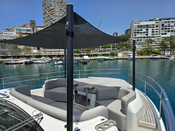 Orca Yacht Photos Pics 2023 Cranchi Sessantasette 67 yacht with shaded seating area in a marina.