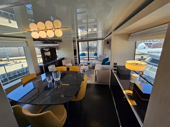 Orca Yacht Photos Pics Luxurious interior of 2023 Cranchi Sessantasette 67 yacht with modern dining and living area.