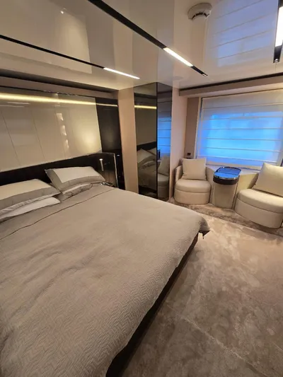 Orca Yacht Photos Pics Luxurious bedroom interior of 2023 Cranchi Sessantasette 67 yacht, featuring modern design and cozy seating.