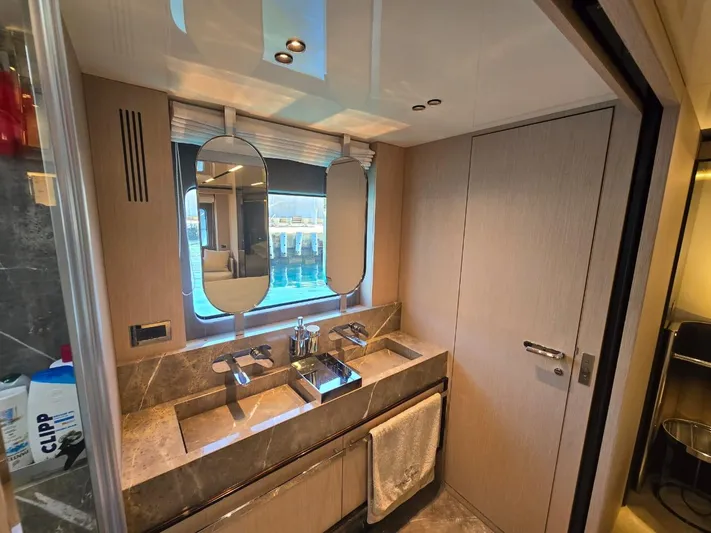 Orca Yacht Photos Pics Luxurious bathroom in 2023 Cranchi Sessantasette 67 yacht with dual sinks and modern fixtures.