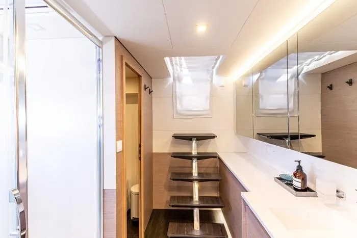 Port To Vino 2 Yacht Photos Pics Modern bathroom interior on 2023 Fountaine Pajot Samana 59 yacht, featuring sleek design elements.
