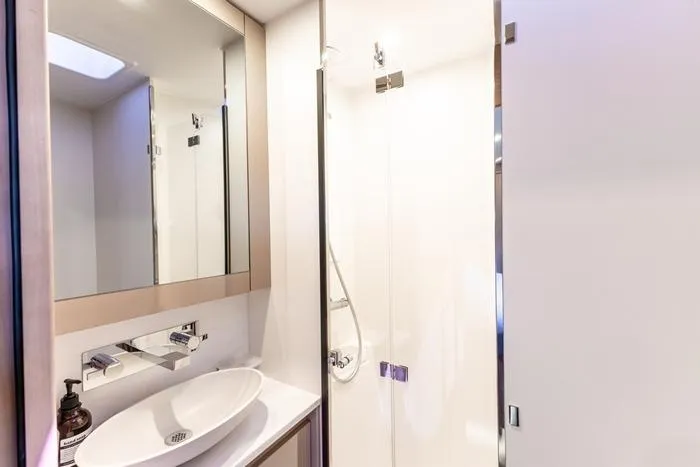 Port To Vino 2 Yacht Photos Pics Modern bathroom interior on 2023 Fountaine Pajot Samana 59 yacht, featuring sleek fixtures and elegant design.