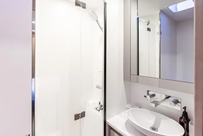 Port To Vino 2 Yacht Photos Pics Modern bathroom in 2023 Fountaine Pajot Samana 59 yacht with sleek fixtures and shower.