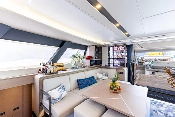 Port To Vino 2 Yacht Photos Pics Luxurious interior of 2023 Fountaine Pajot Samana 59 yacht with elegant dining area.