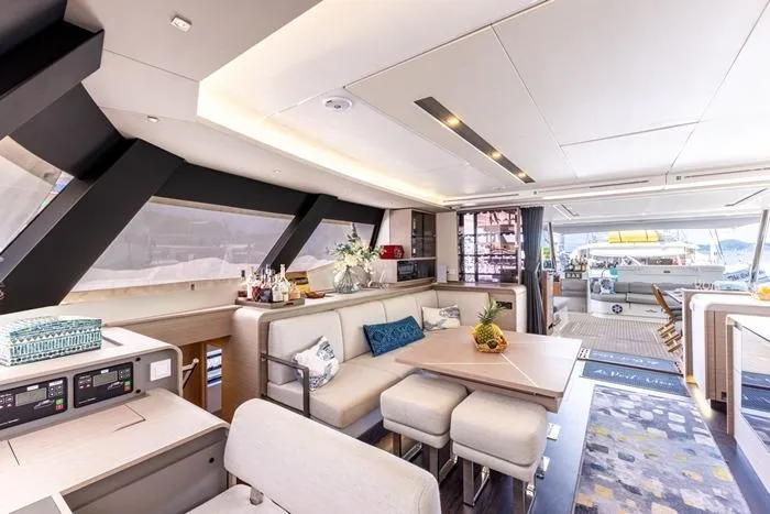 Port To Vino 2 Yacht Photos Pics Luxurious interior of 2023 Fountaine Pajot Samana 59 yacht with modern furnishings.