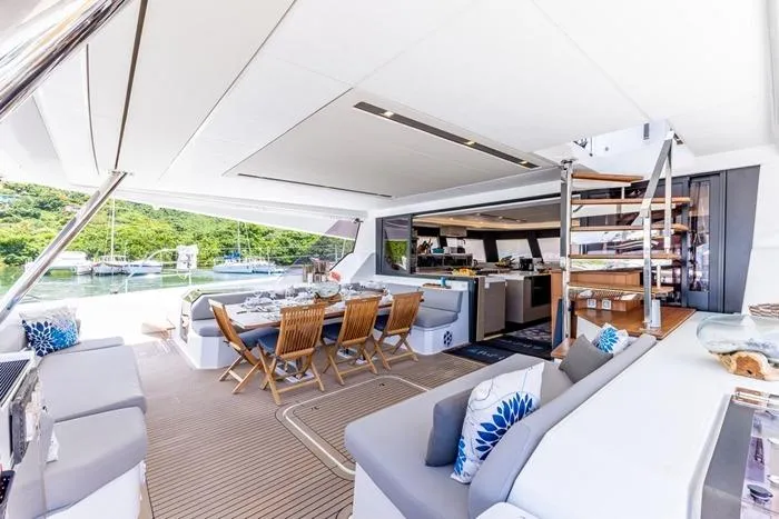 Port To Vino 2 Yacht Photos Pics Luxurious 2023 Fountaine Pajot Samana 59 yacht interior with elegant dining area and modern design.
