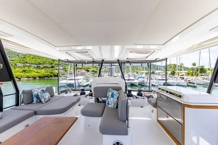 Port To Vino 2 Yacht Photos Pics Luxurious interior of 2023 Fountaine Pajot Samana 59 yacht with marina view.