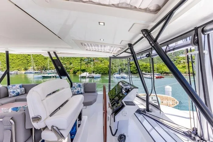 Port To Vino 2 Yacht Photos Pics Luxurious 2023 Fountaine Pajot Samana 59 yacht interior with scenic marina view.