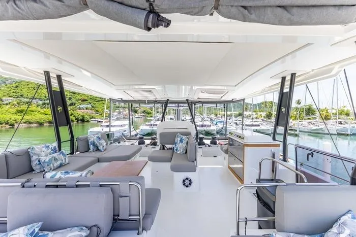 Port To Vino 2 Yacht Photos Pics Luxurious interior of 2023 Fountaine Pajot Samana 59 yacht with marina view.