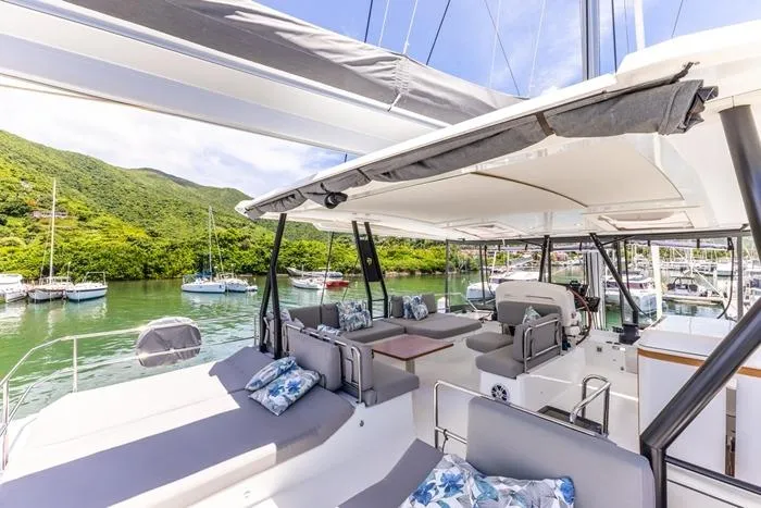 Port To Vino 2 Yacht Photos Pics Luxurious 2023 Fountaine Pajot Samana 59 yacht with spacious deck and scenic marina view.