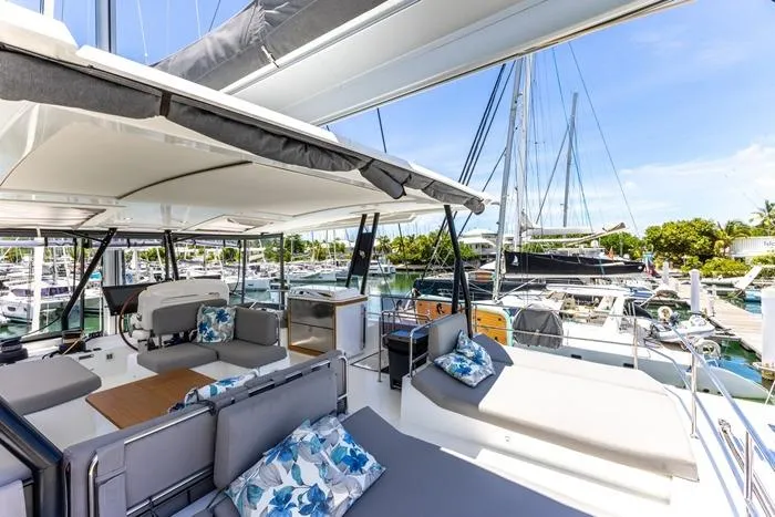 Port To Vino 2 Yacht Photos Pics Luxurious 2023 Fountaine Pajot Samana 59 yacht with spacious deck and marina view.