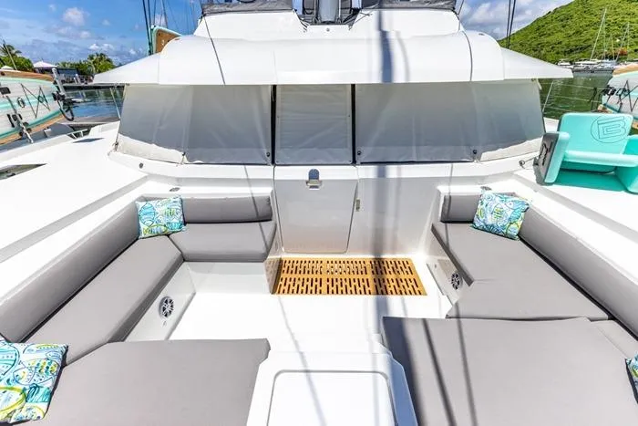 Port To Vino 2 Yacht Photos Pics 2023 Fountaine Pajot Samana 59 yacht with spacious outdoor seating and decorative cushions.