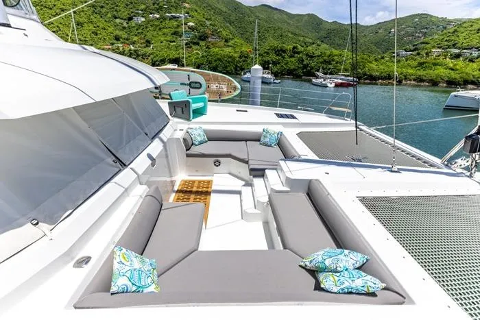 Port To Vino 2 Yacht Photos Pics Luxurious 2023 Fountaine Pajot Samana 59 yacht with spacious deck seating and scenic marina view.