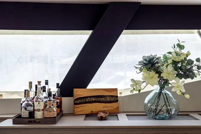 Port To Vino 2 Yacht Photos Pics Interior of 2023 Fountaine Pajot Samana 59 yacht with bar setup and floral decor.