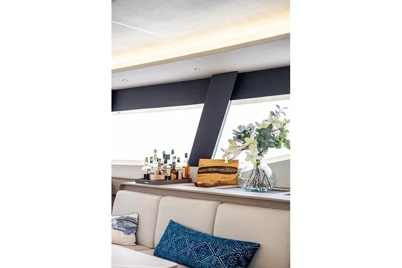 Port To Vino 2 Yacht Photos Pics Luxurious interior of 2023 Fountaine Pajot Samana 59 yacht with elegant decor and bar setup.
