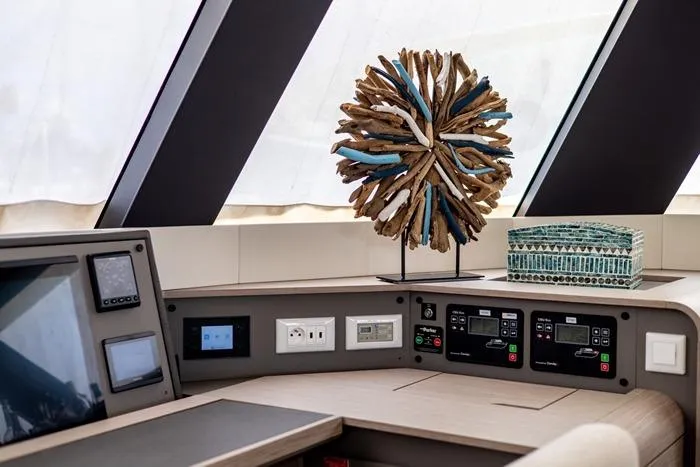 Port To Vino 2 Yacht Photos Pics Control panel of 2023 Fountaine Pajot Samana 59 yacht with decorative sculpture.