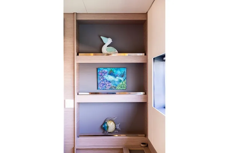 Port To Vino 2 Yacht Photos Pics Modern interior shelving on 2023 Fountaine Pajot Samana 59 yacht with decorative items.
