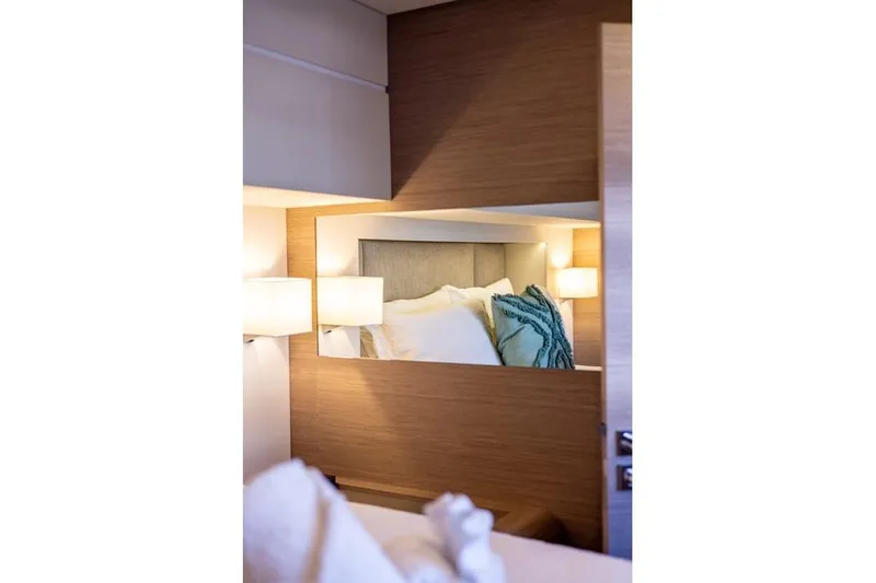 Port To Vino 2 Yacht Photos Pics Luxurious cabin interior of 2023 Fountaine Pajot Samana 59 yacht with elegant bedding.