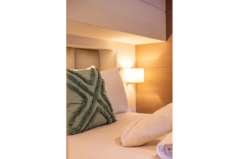 Port To Vino 2 Yacht Photos Pics Luxurious bedroom interior of 2023 Fountaine Pajot Samana 59 yacht with elegant decor.