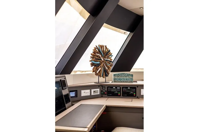 Port To Vino 2 Yacht Photos Pics Interior of 2023 Fountaine Pajot Samana 59 yacht with modern decor and control panels.