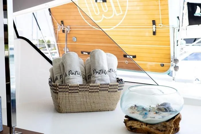 Port To Vino 2 Yacht Photos Pics Basket with rolled towels on Fountaine Pajot Samana 59 yacht, 2023 model.
