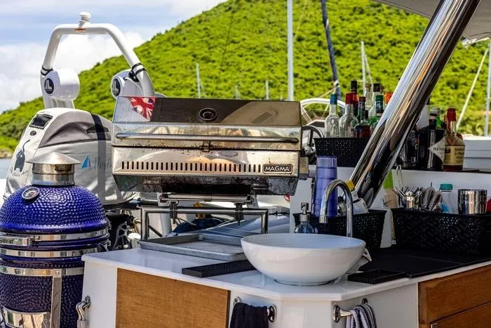 Port To Vino 2 Yacht Photos Pics Outdoor kitchen on 2023 Fountaine Pajot Samana 59 yacht with grill and sink.