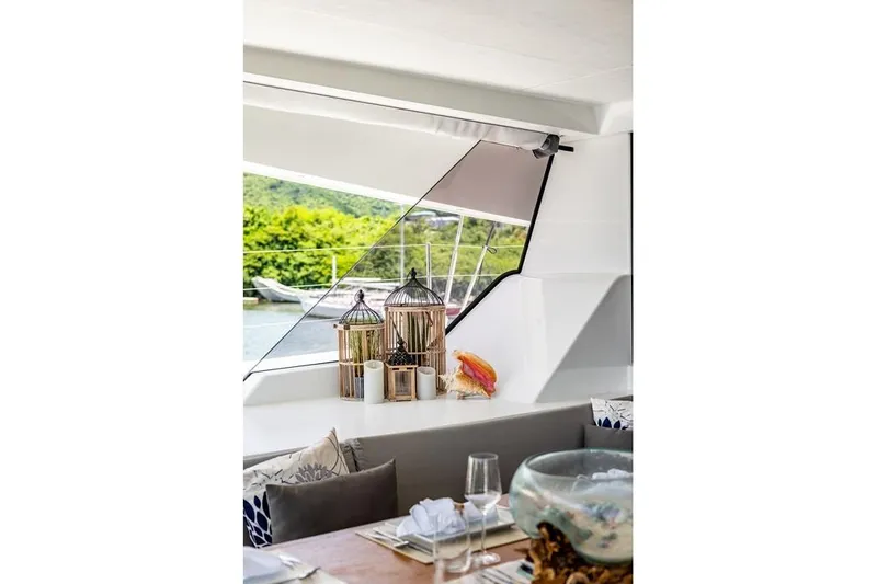 Port To Vino 2 Yacht Photos Pics Interior of 2023 Fountaine Pajot Samana 59 yacht with elegant decor and scenic view.