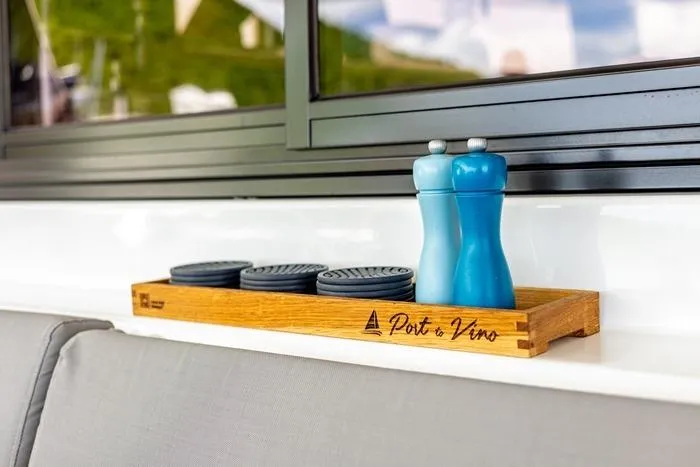 Port To Vino 2 Yacht Photos Pics Wooden tray with blue salt and pepper shakers on Fountaine Pajot Samana 59 yacht, 2023.