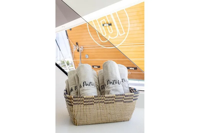 Port To Vino 2 Yacht Photos Pics Basket with rolled towels on Fountaine Pajot Samana 59 yacht, 2023 model.