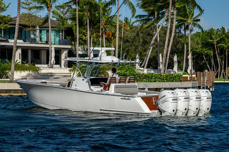 Farniente Yacht Photos Pics 2022 Valhalla Boatworks V41 cruising near palm-lined waterfront homes.