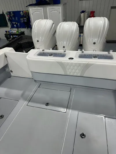  Yacht Photos Pics 2024 Contender 39 ST boat with triple outboard engines in a showroom.