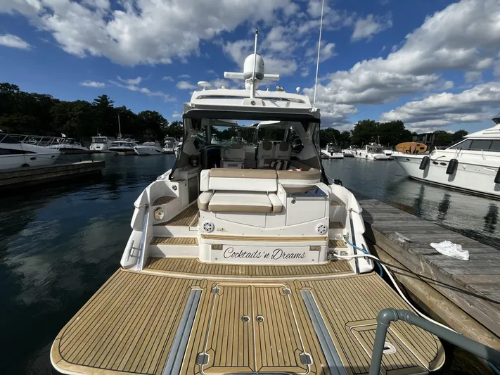  Yacht Photos Pics 2014 Four Winns V435 yacht docked at marina under blue sky.