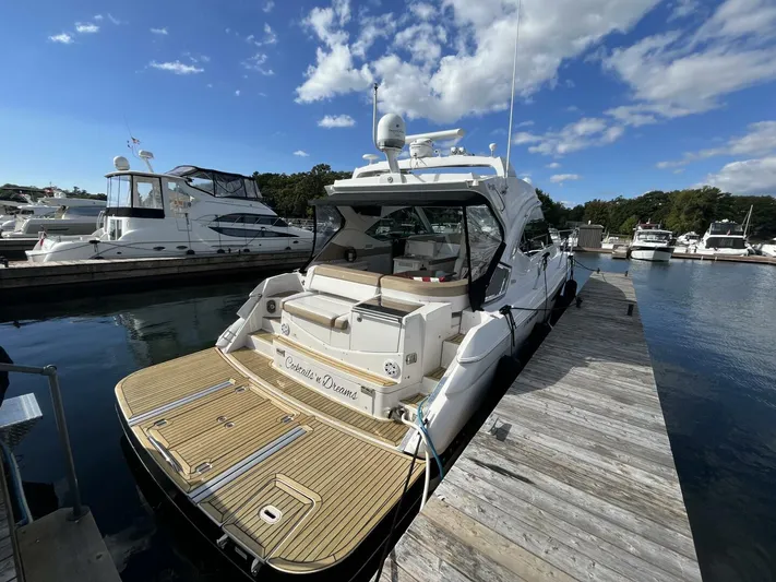  Yacht Photos Pics 2014 Four Winns V435 yacht docked at marina under blue sky.
